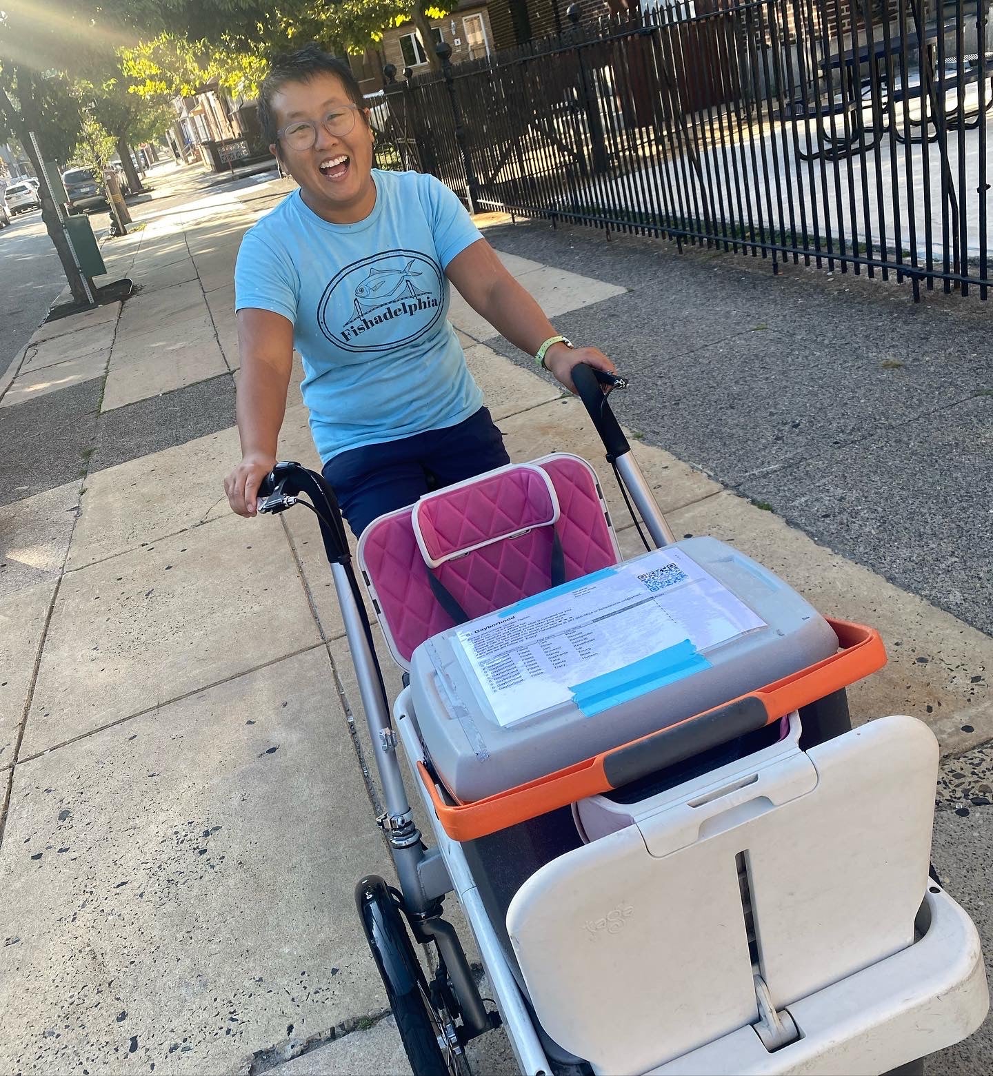 Talia with Fishadelphia coolers on a street corner.