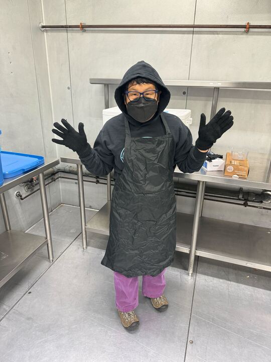 Talia holds up her hands in the Alt Kitchen cold room during fish packing